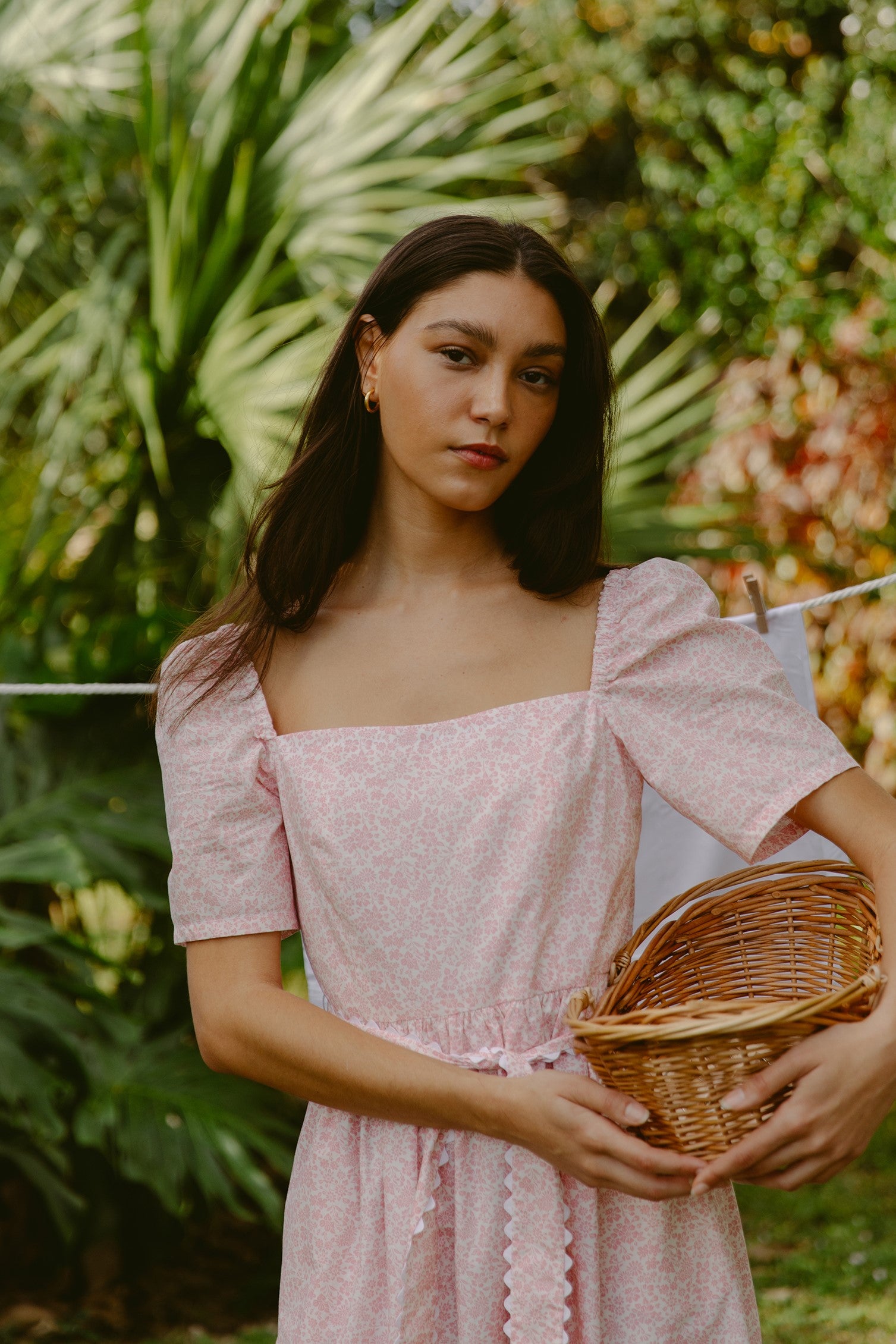 Woman in a pink dress holding a basket