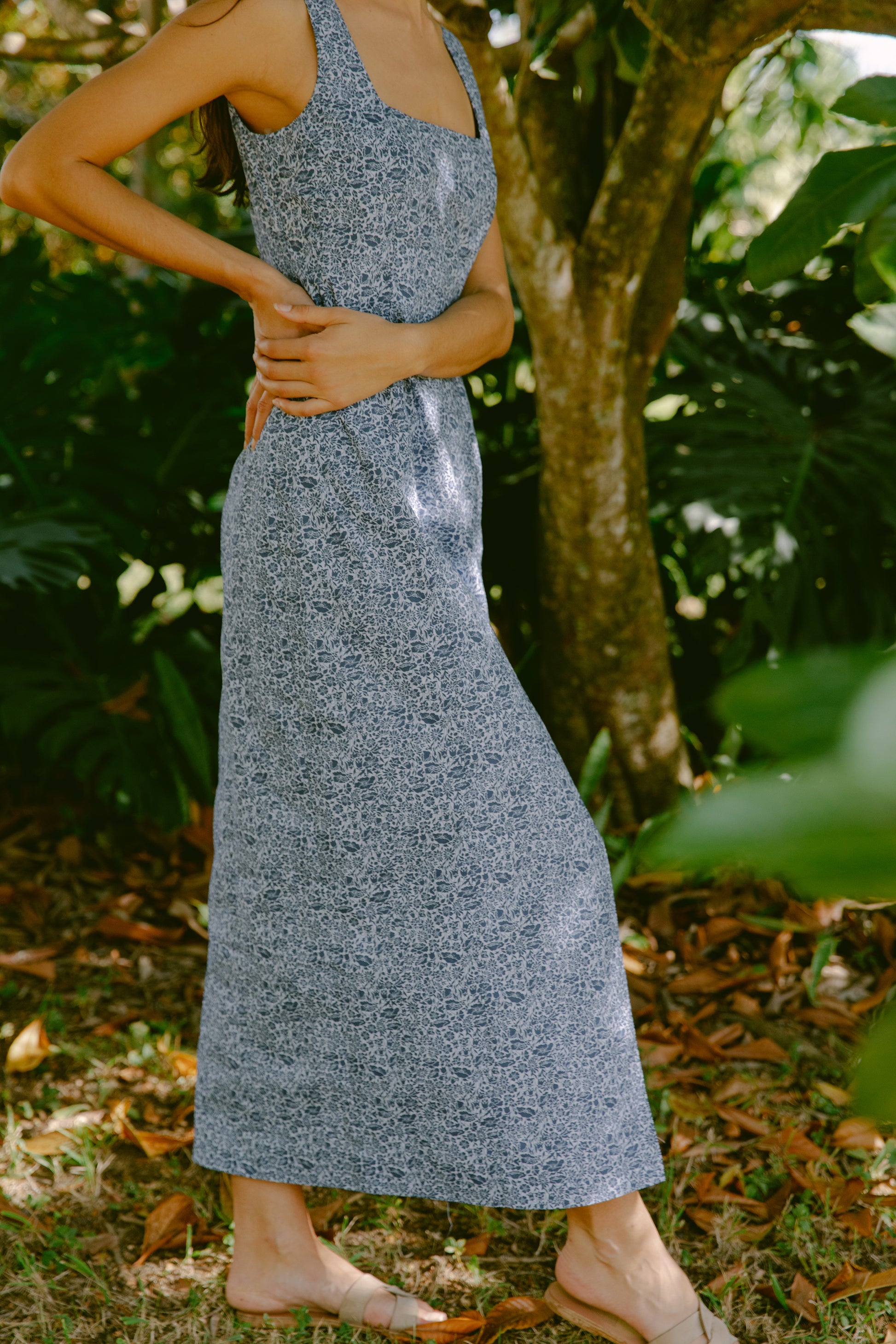 Side view of woman in blue floral maxi dress