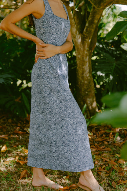 Side view of woman in blue floral maxi dress