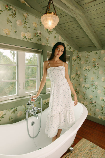 Woman in white dress with blue daisies