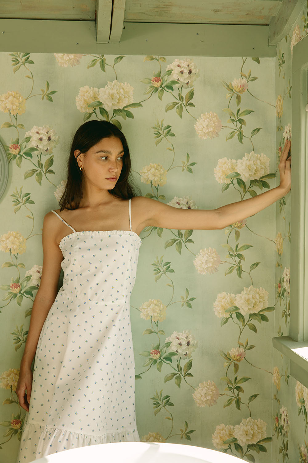Woman in white dress with blue daisies