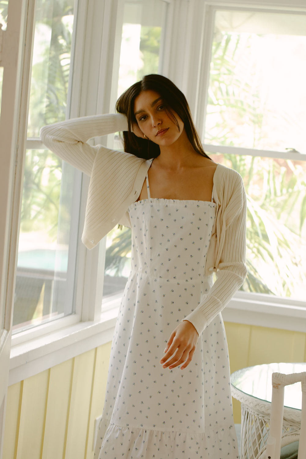 Woman in white dress with blue daisies
